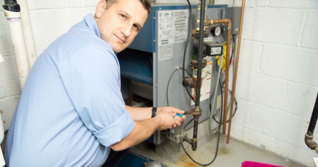 repairman working on gas furnace