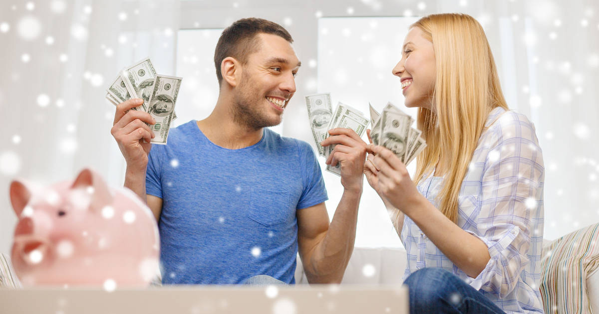 smiling couple holding cash