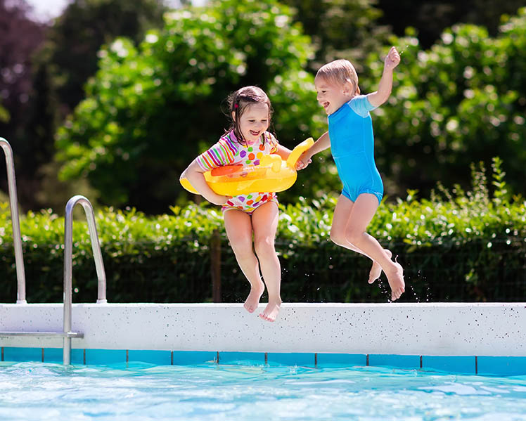 kids jumping into pool