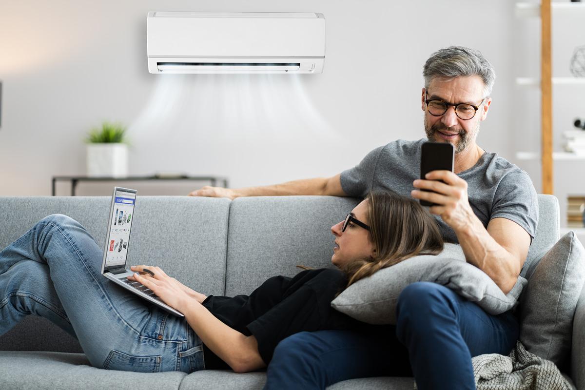 Family sitting on couch using AC