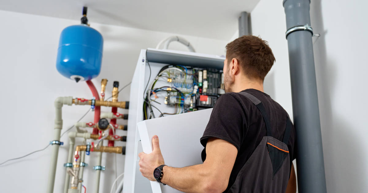 man maintaining boiler